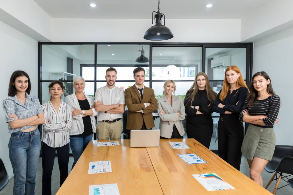 Diverse colleagues gather in brainstorm discuss statistics together.